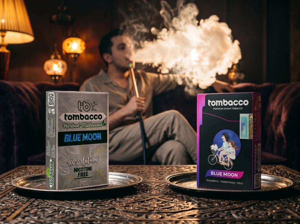 A friendly side-by-side comparison of Tombacco products on a metal tray, helping you decide between herbal or tobacco shisha. It shows a silver box of 'Blue Moon' herbal molasses and a black box of tobacco shisha, while a man enjoys a thick smoke cloud in the background.