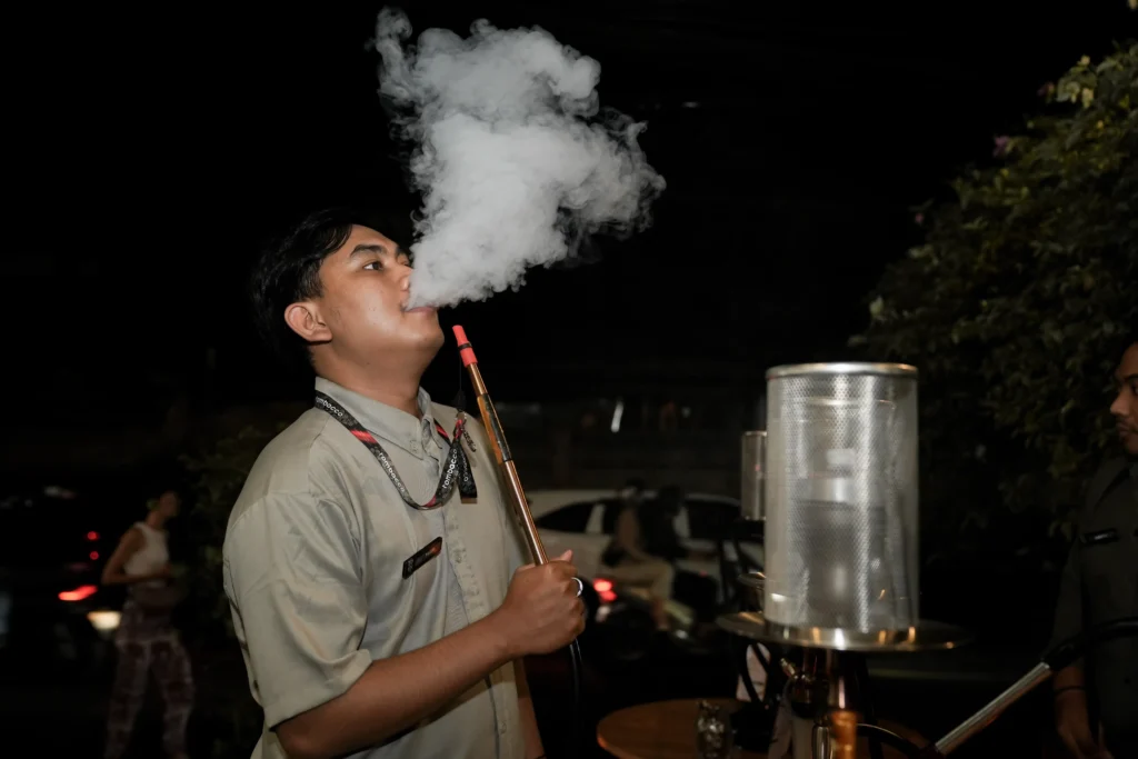 Enjoying a shisha session after preparing the hookah and managing the heat