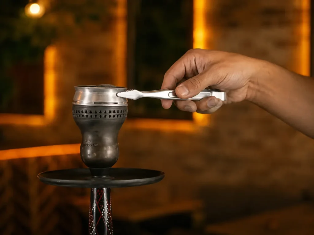 Placing a heat management device on a packed shisha bowl